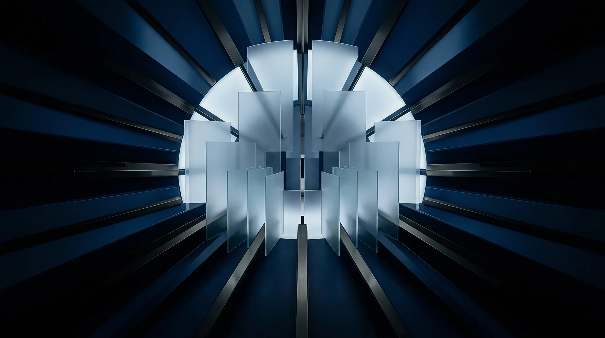 Light fans out in radial blades from a dark machine core; navy tonal render.